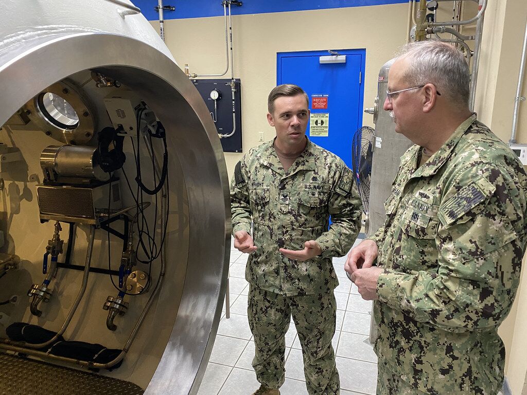 military personnel near decompression chamber